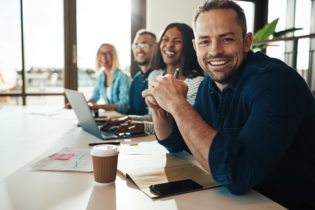 Picture of smiling employees in a row.