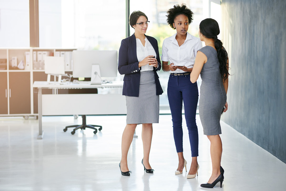 Three women in office talking
