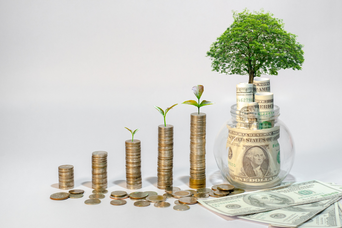 Growing stacks of coins with sprouts coming out of them, jar with money inside with tree growing out of it