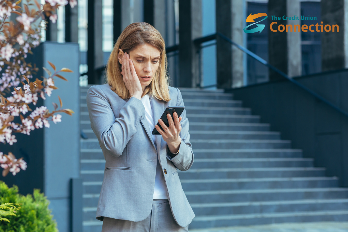 Woman looking at cellphone worriedly, CUC logo in upper right corner