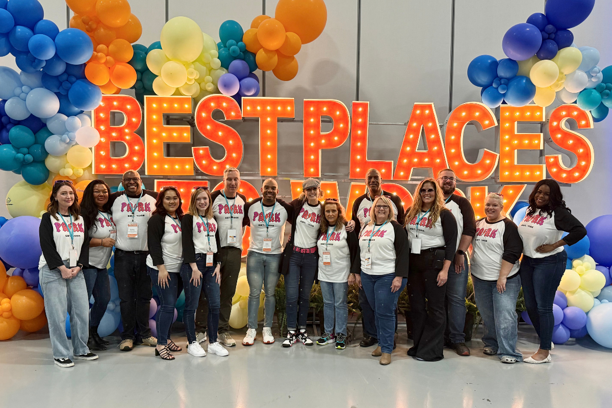 group of Park Community Credit Union employees holding up letters that spell best place