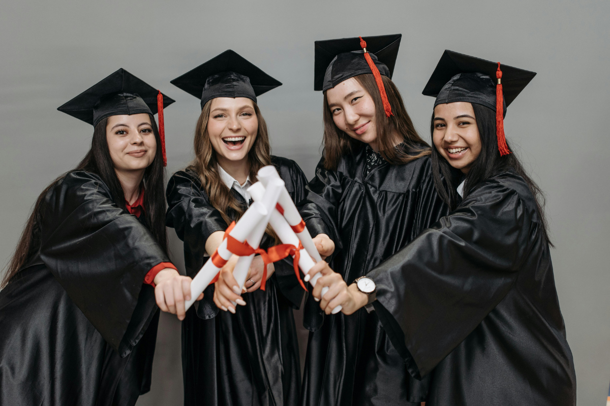 Group of graduating students holding diplomas