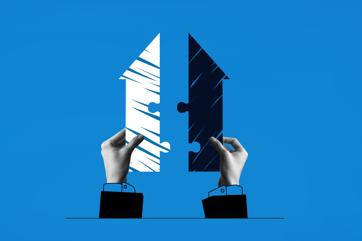 2 hands putting together 2 puzzle pieces, merger concept