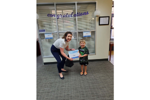 Youth member Parks Hamilton received his Summer Camp Award from Raleigh-Wakefield's Assistant Branch Manager Shannon DeMaria.