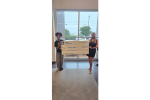 2025 MyWay Scholarship Georgia recipient Mikayla Watts (left) is presented with a check from First Commerce Georgia Market Executive Tiffany McCall.