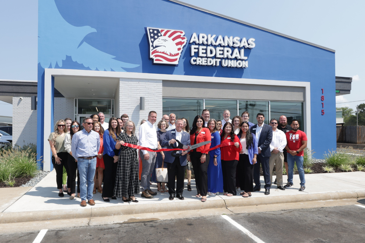 Ribbon cutting with multiple people in front of new Arkansas Federal Credit Union branch