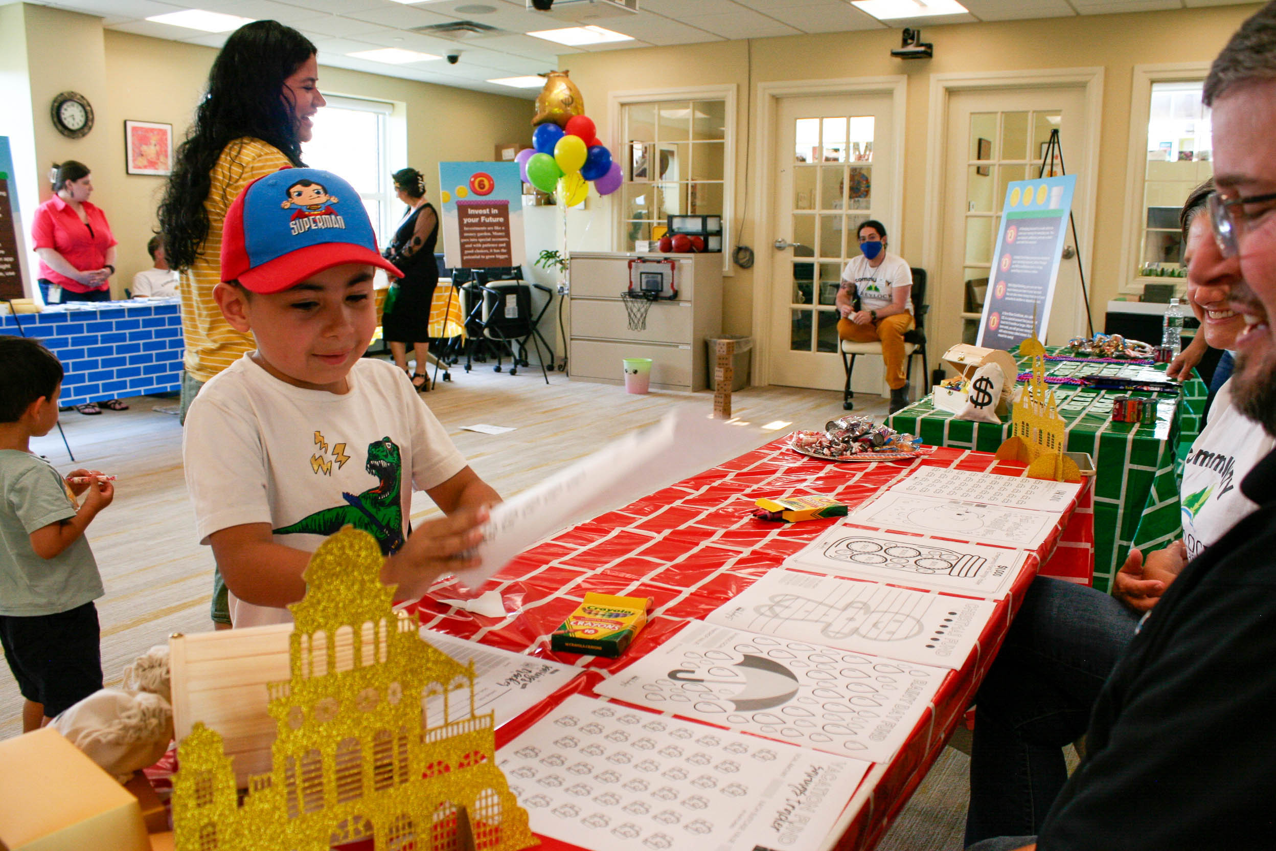 A young Wealth Builder playing a financial game inside the Community Empowerment Center.