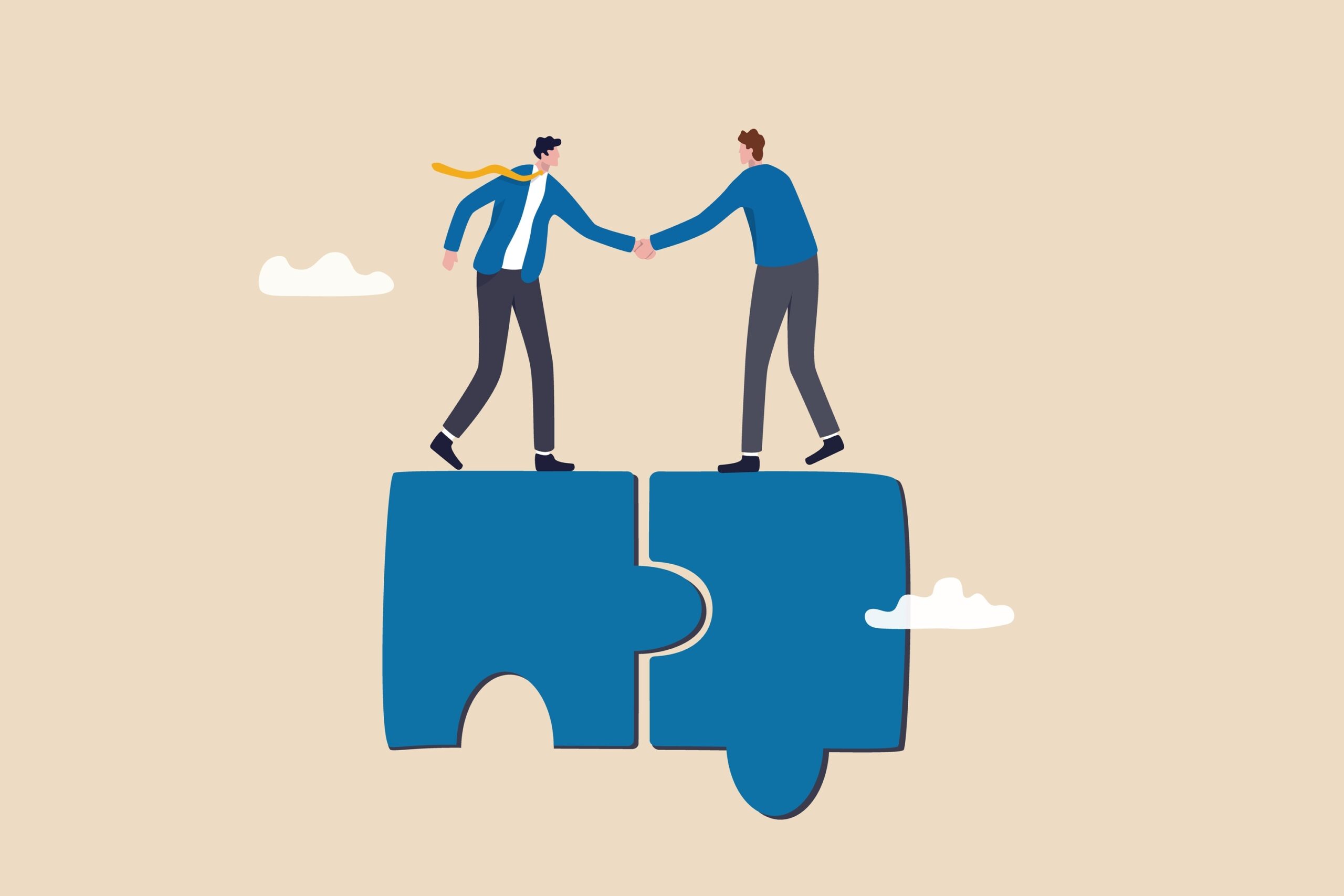 Two people on top of puzzle pieces shaking hands