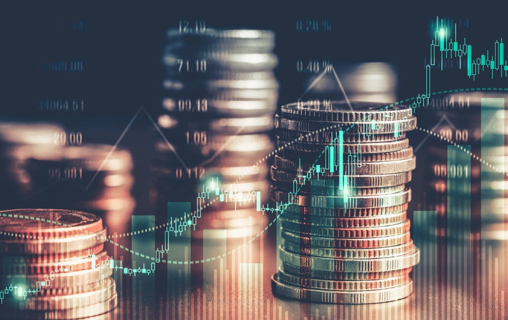 Stacks of coins; lines of data in front of coins