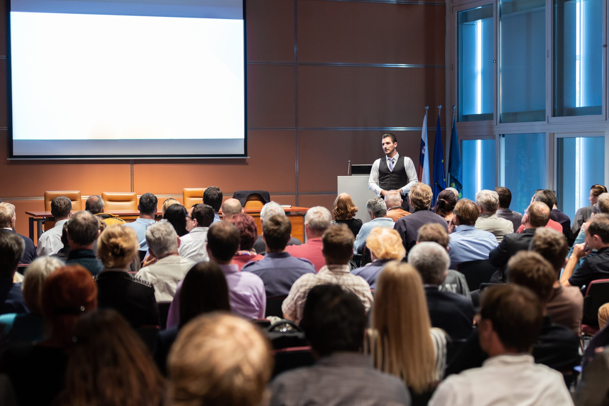 Speaker talking in packed conference hall