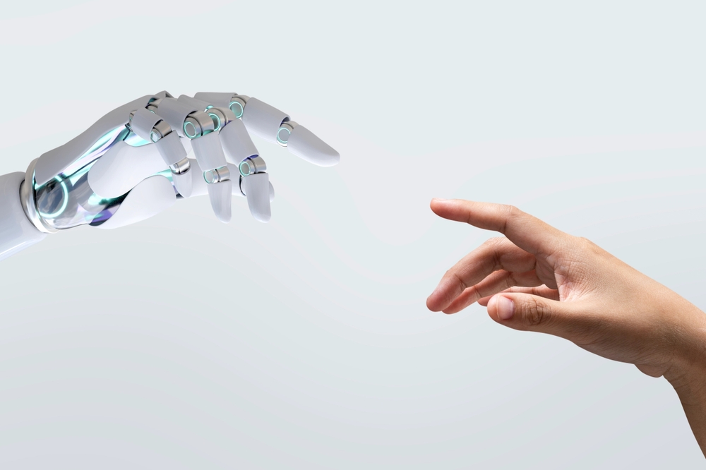 Robot and human hands reaching out for each other