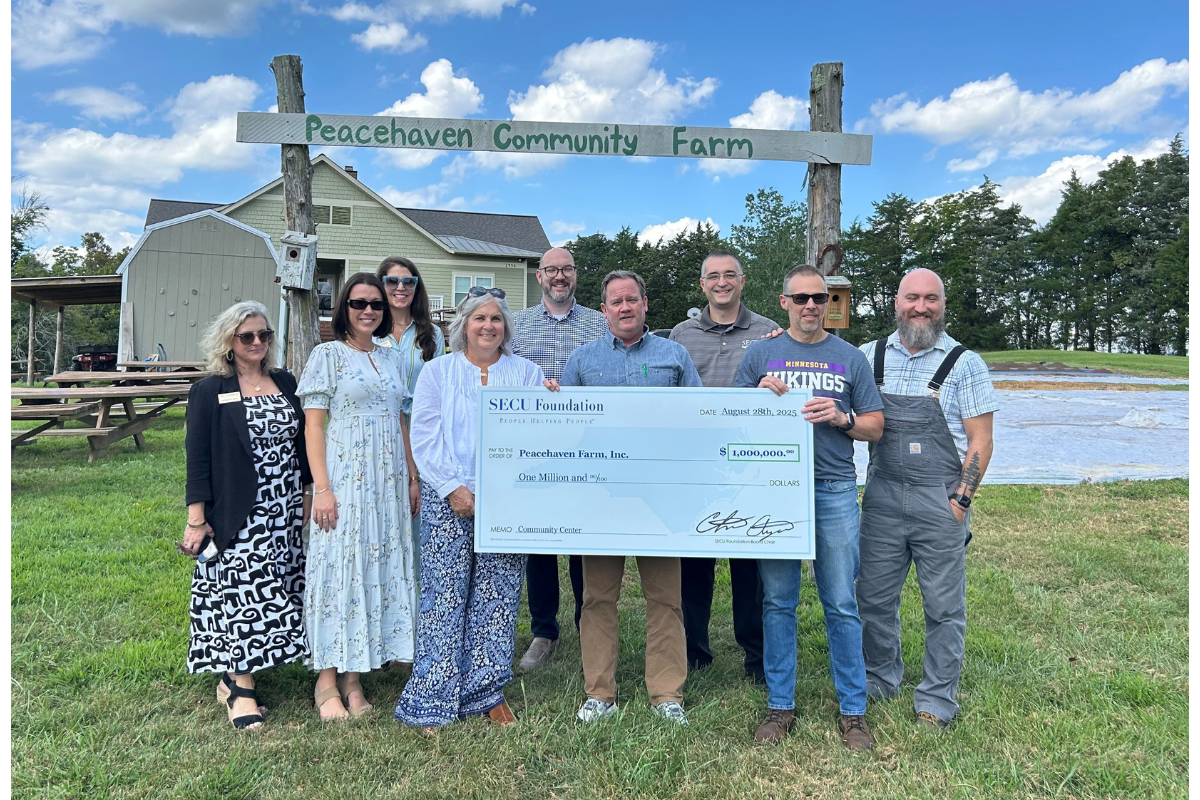 Holding the check left to right are Peacehaven Board Chair Heidi Norwick, Peacehaven CEO Phelps Sprinkle, and Peacehaven Director of Finance and Operations Ray Schwarz, surrounded by SECU, SECU Foundation, and Peacehaven Farm, Inc. representatives.
