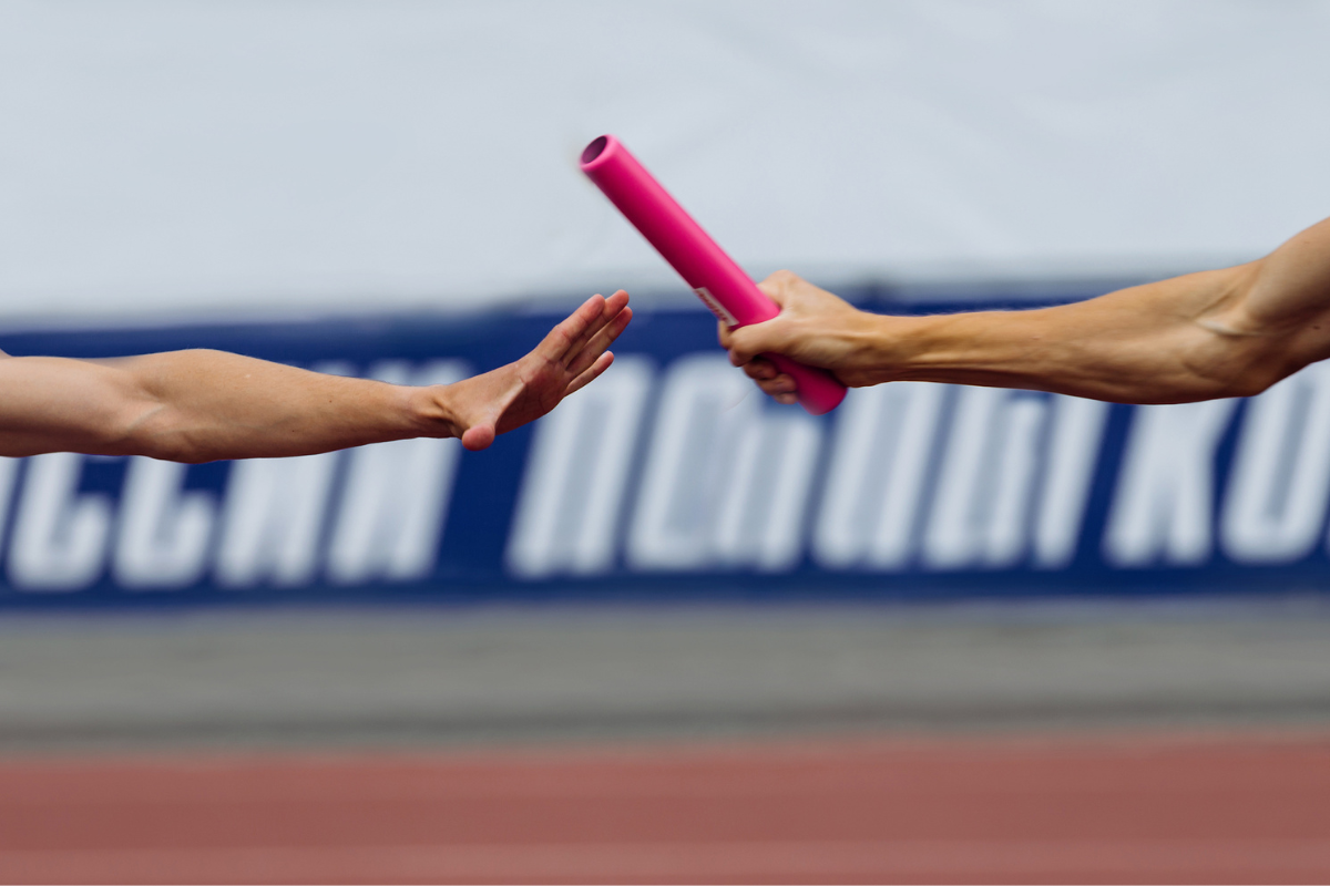 hands men runners passing baton in relay race