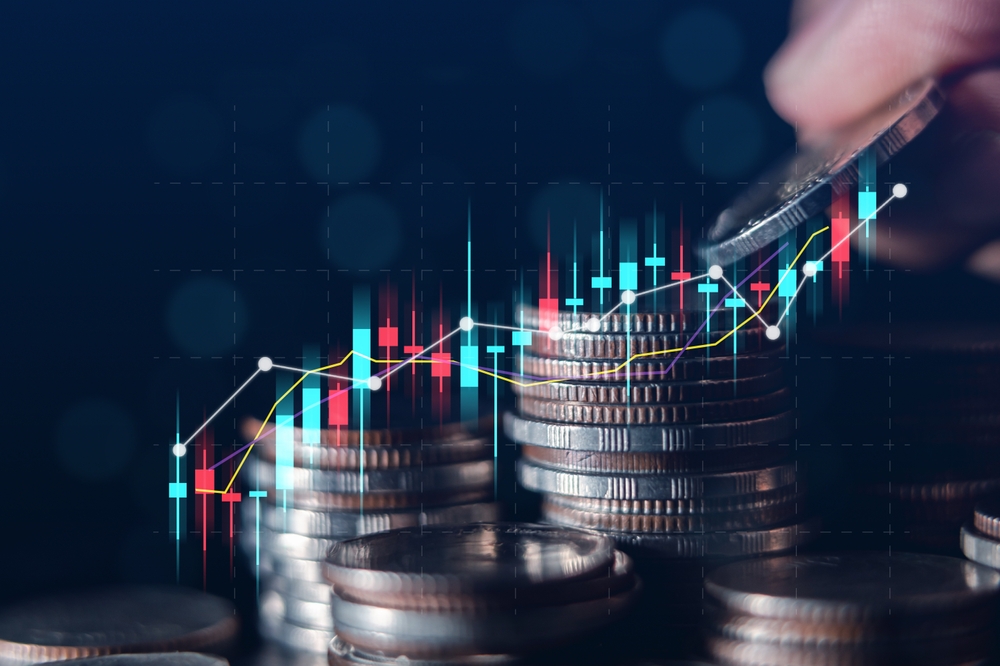 Stacks of coins with data and graphs in front of them