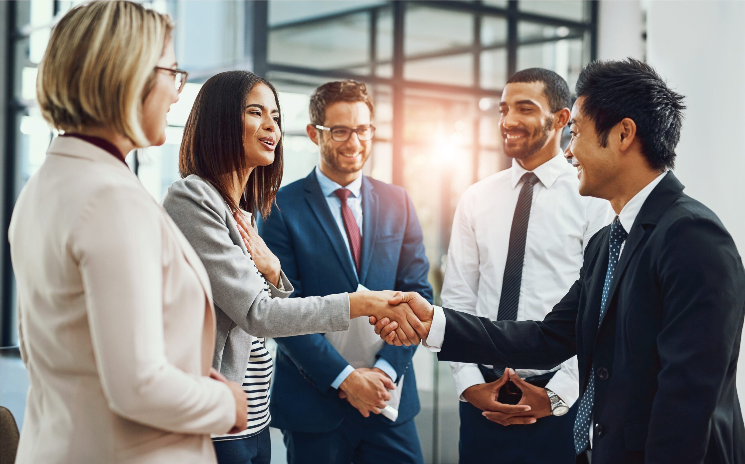 Group of businesspeople; man and woman shaking hands