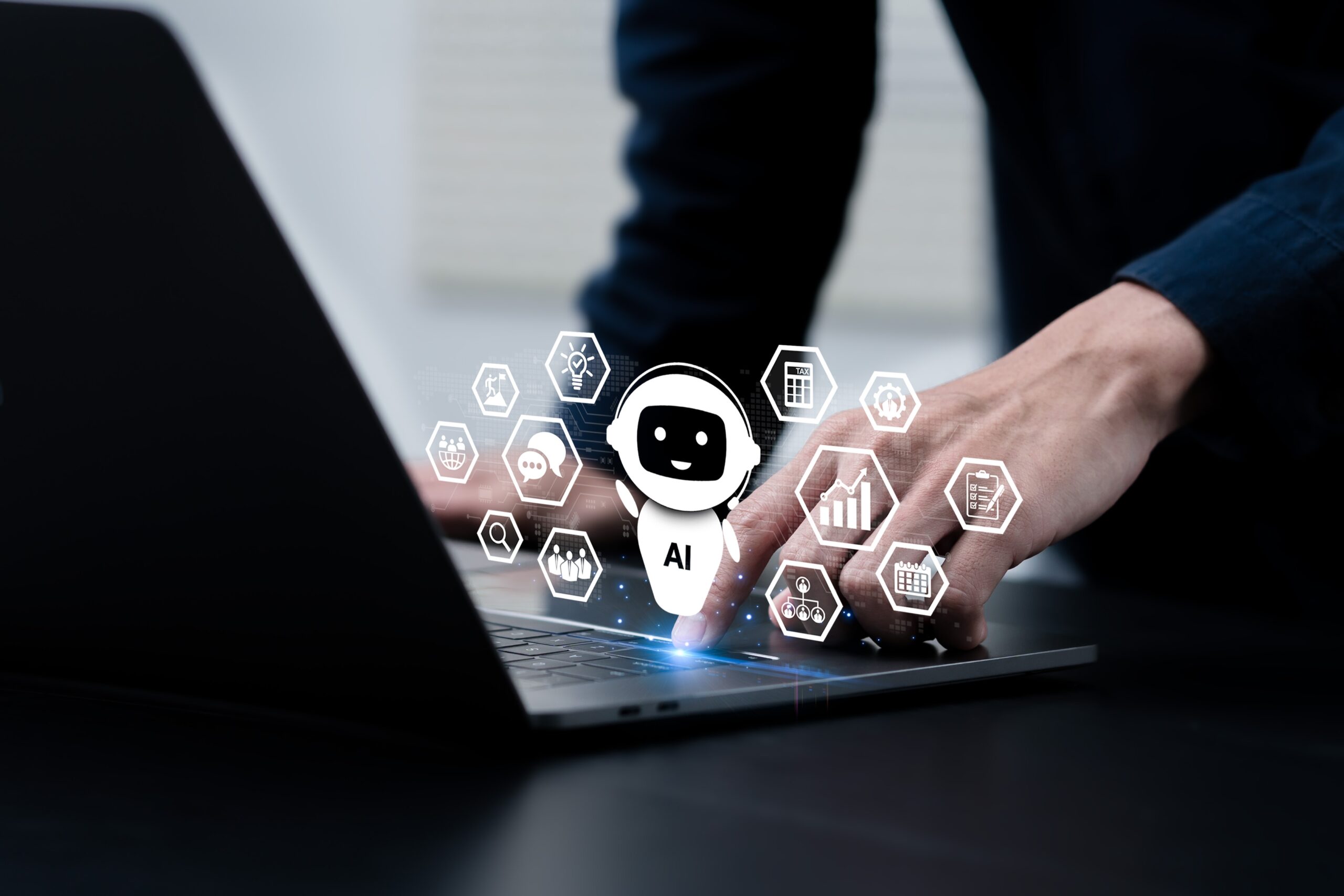 Person using laptop; AI wearing headset floating above laptop keyboard