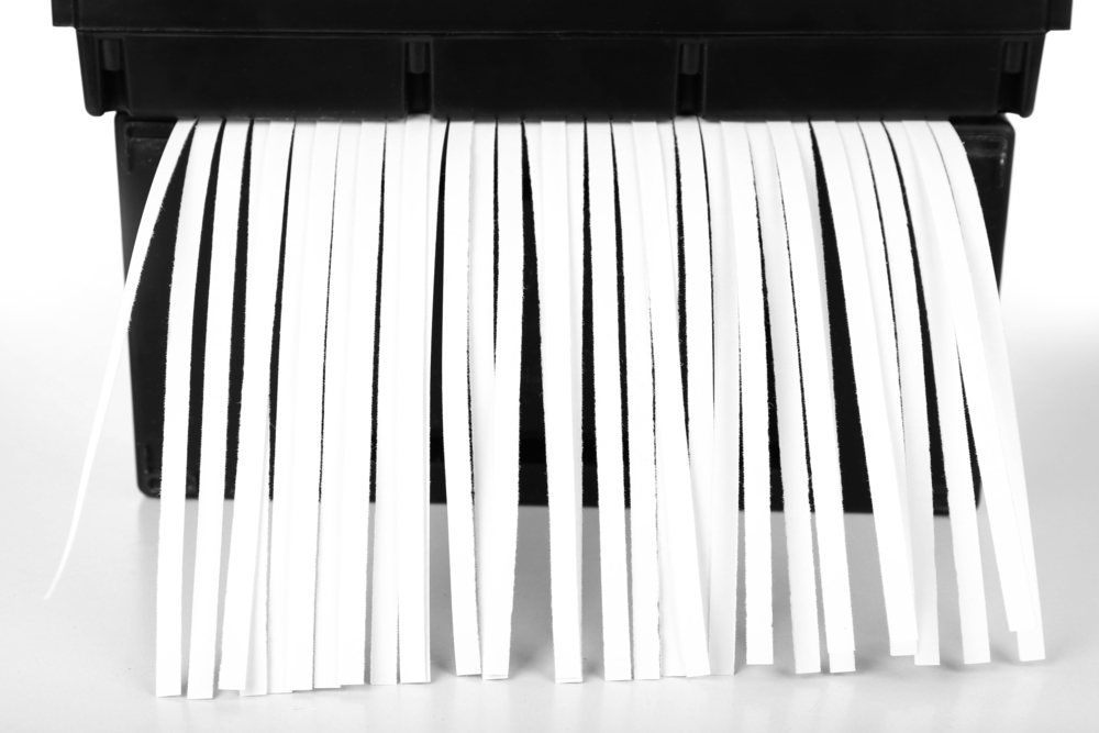 Strips of paper coming out of a paper shredder
