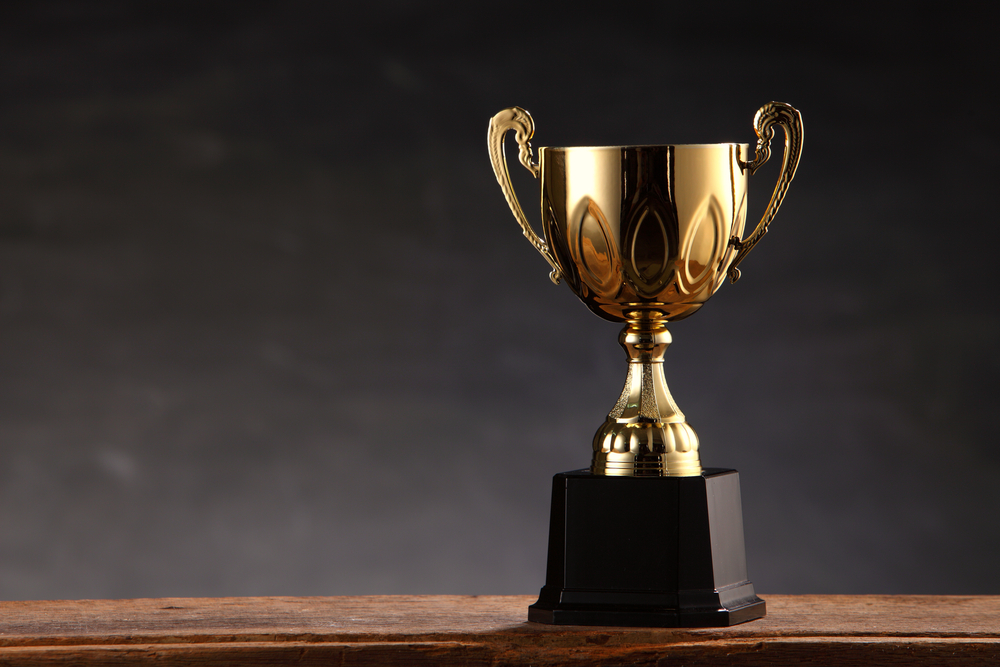 Gold trophy on wooden table