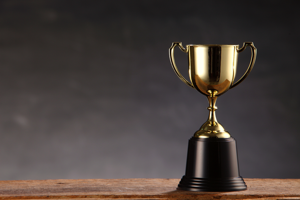 Gold trophy on wooden table