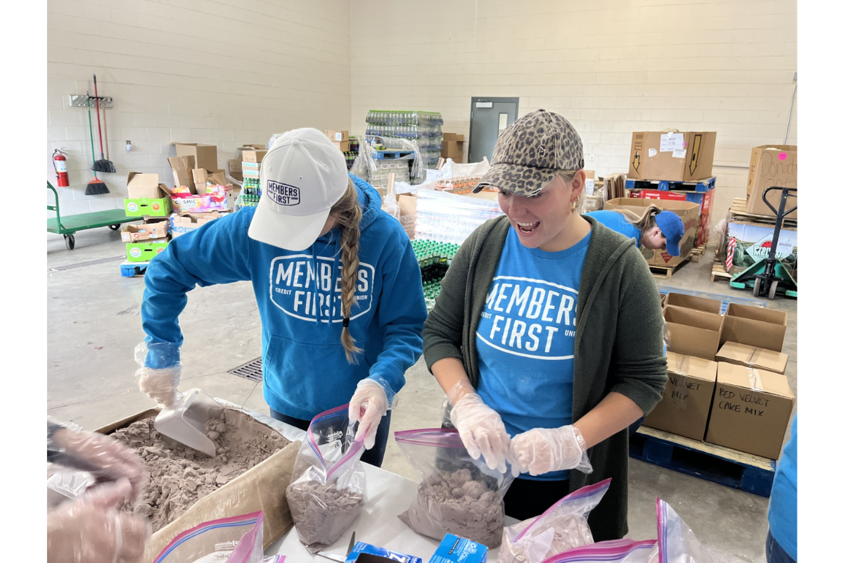 Members First CU- Two employees doing volunteer work