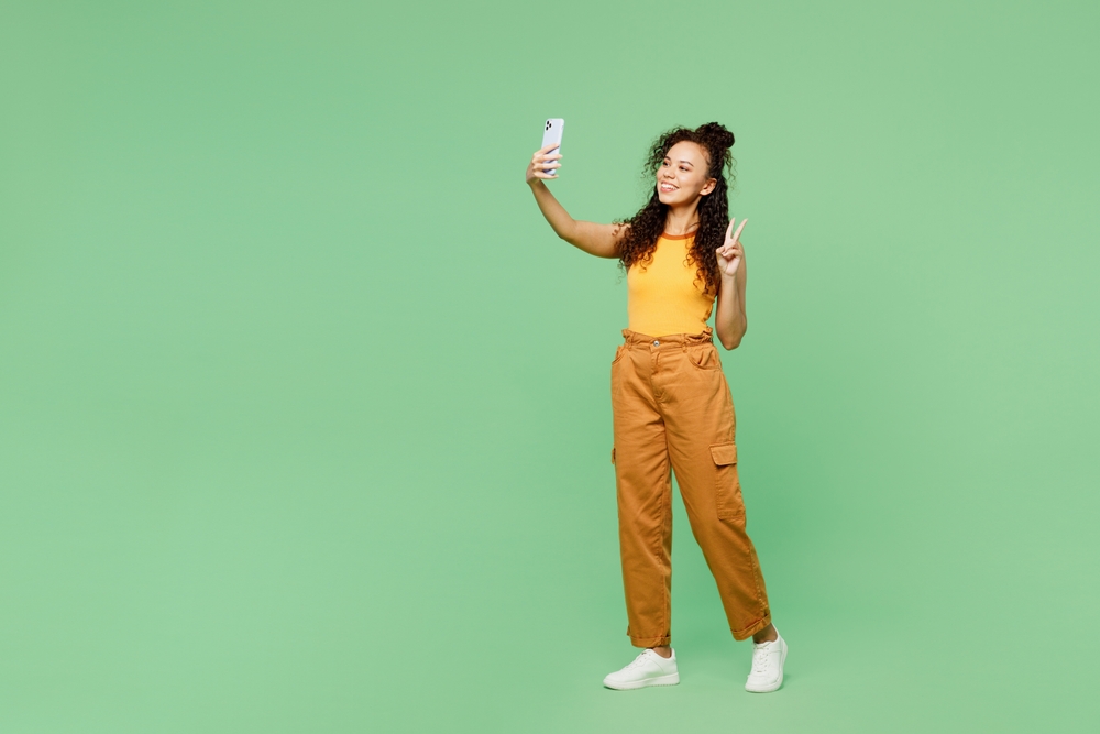 Woman holding up smartphone to take a selfie