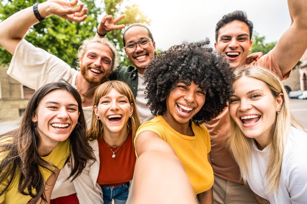 Group of people smiling, taking selfie