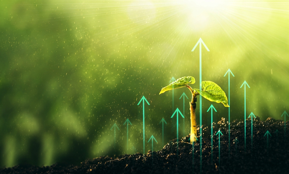 Sprout growing out of the ground; arrows going up around plant