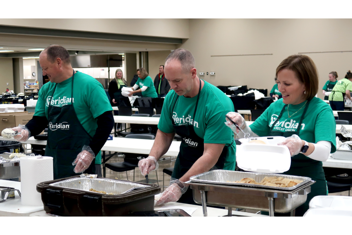 Veridian Credit Union’s Chief Financial Officer Keith Mesch, Chief Information Officer Brett Engstrom and President & CEO Renee Christoffer prepare free meals at the credit union’s 43rd annual Mike & Leona Adams Thanksgiving Dinner in 2024. Veridian recently pledged $100,000 to help fight food insecurity in Iowa; Omaha, Nebraska and Eden Prairie, Minnesota through the 2025 holiday season.