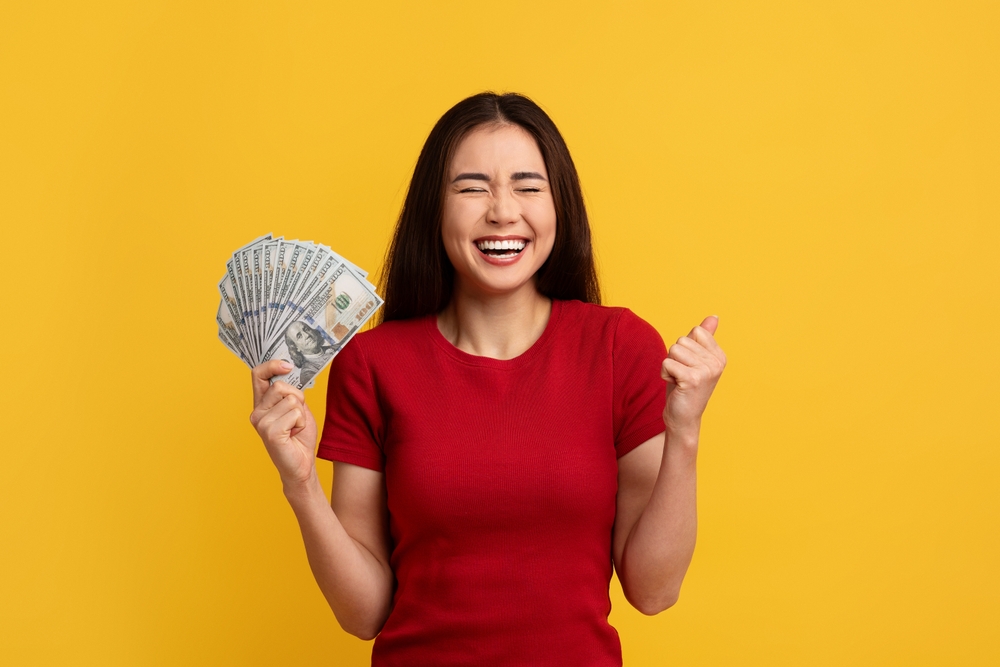 Smiling woman holding cash