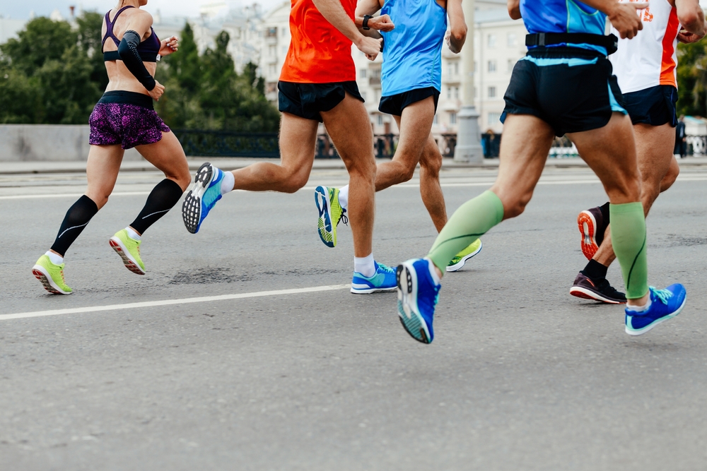 Group of men and women running a marathon