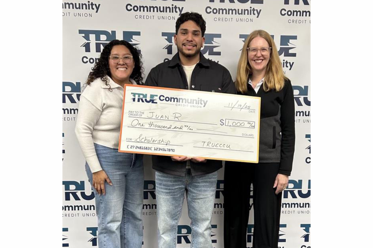Juan Rayas Jr. receiving big check of scholarship
