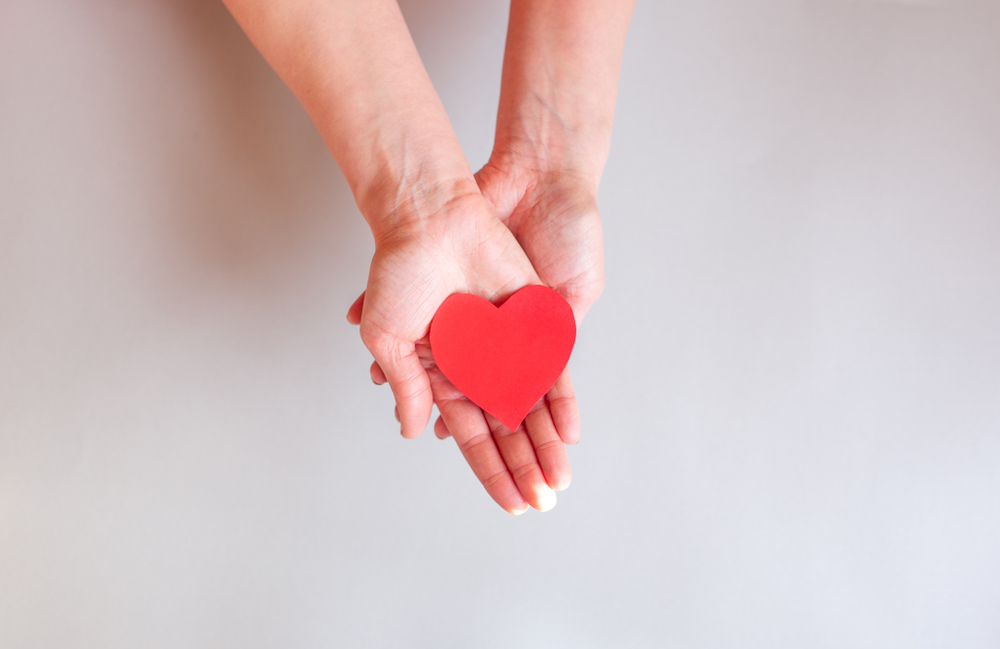 Hands holding red heart