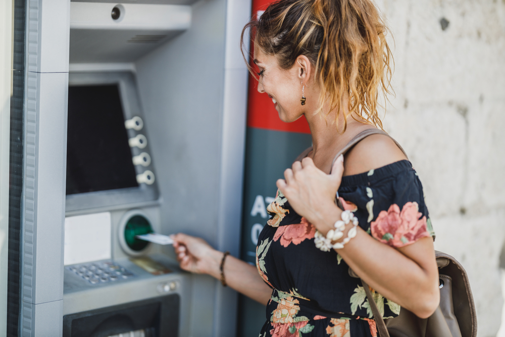 Woman using ATM machine