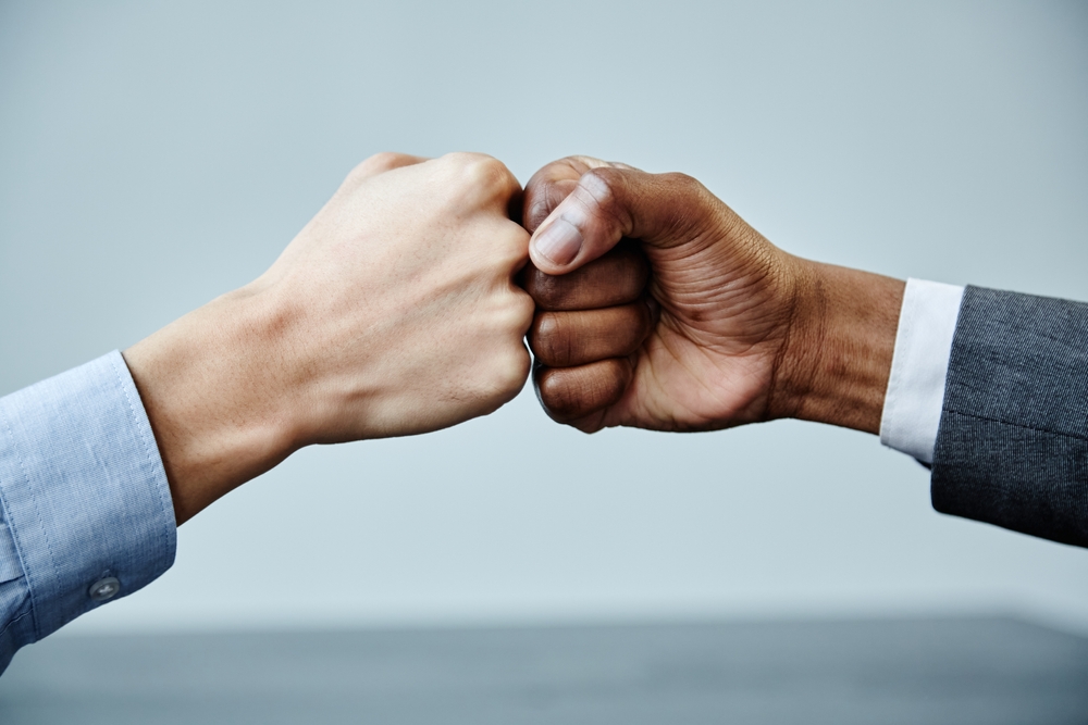 Two businesspeople giving each other a fist bump