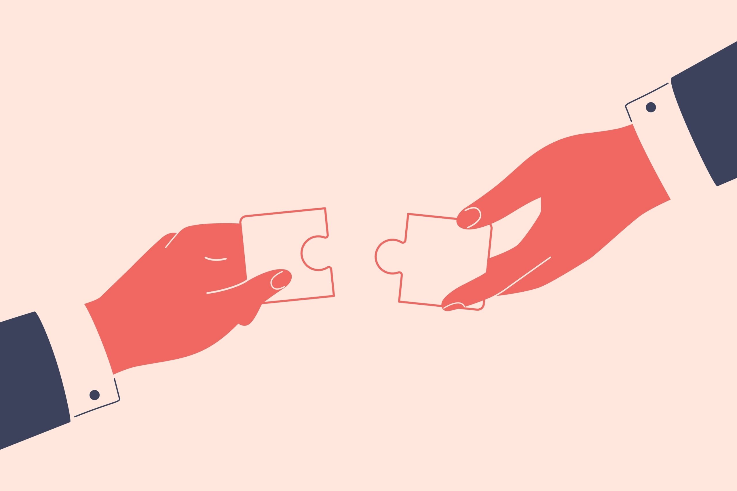 Hands of two businesspeople bringing two puzzle pieces together