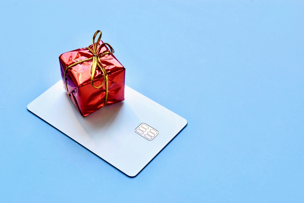 Credit card with red present on top of it