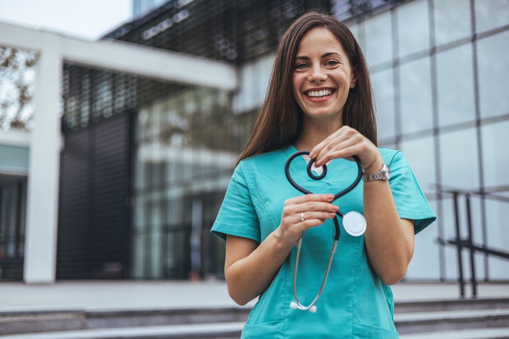 Nurse forming the shape of a heart with her stethoscope