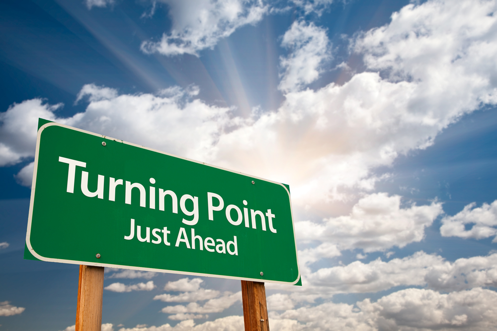 Road sign with "Turning Point Just Ahead" written on it