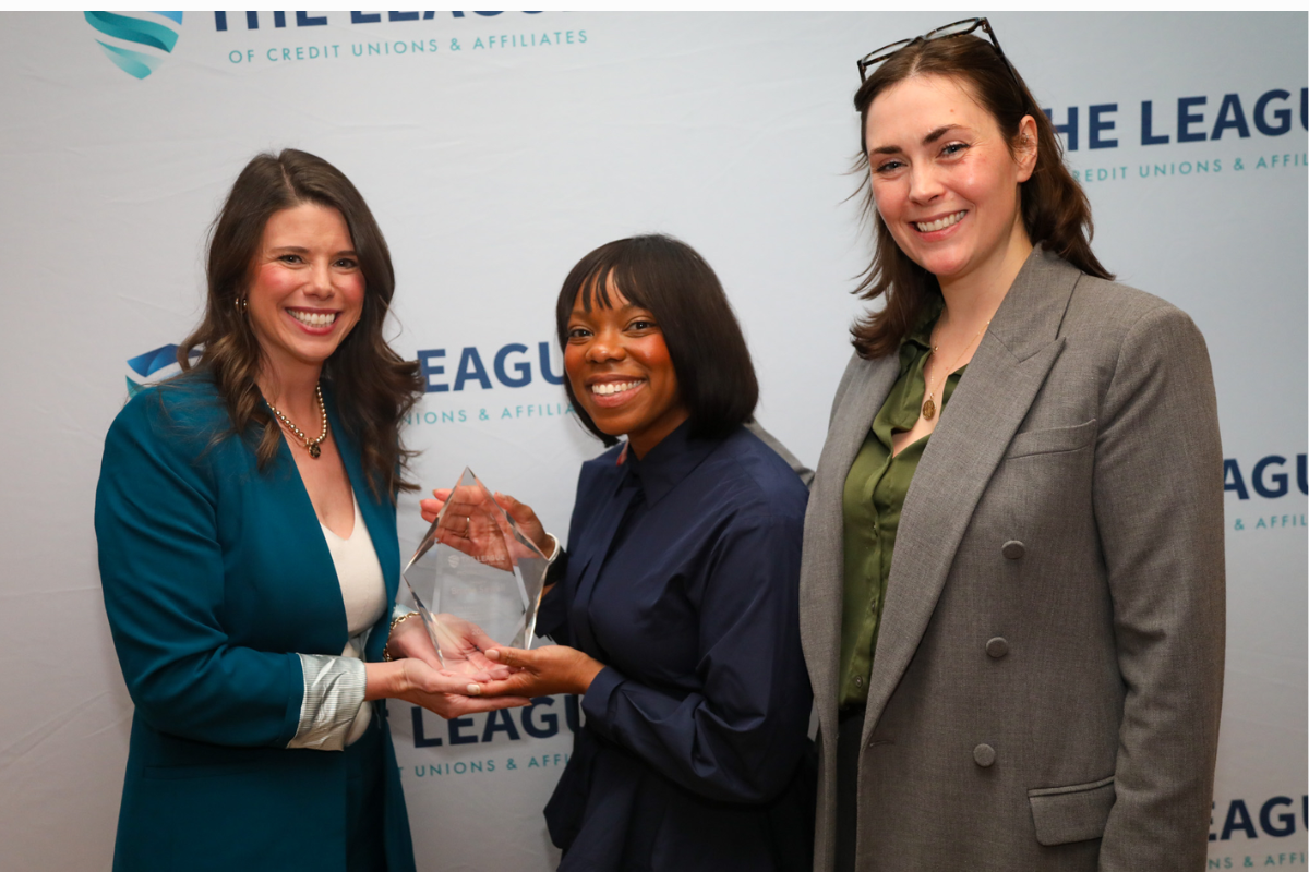photo of Nadine Slocum, Senior Director of Governmental Affairs at The League and Samantha A.M. Beeler, President of The League of Credit Unions & Affiliates giving an award to Delegate Briana Sewell (HD‑25)