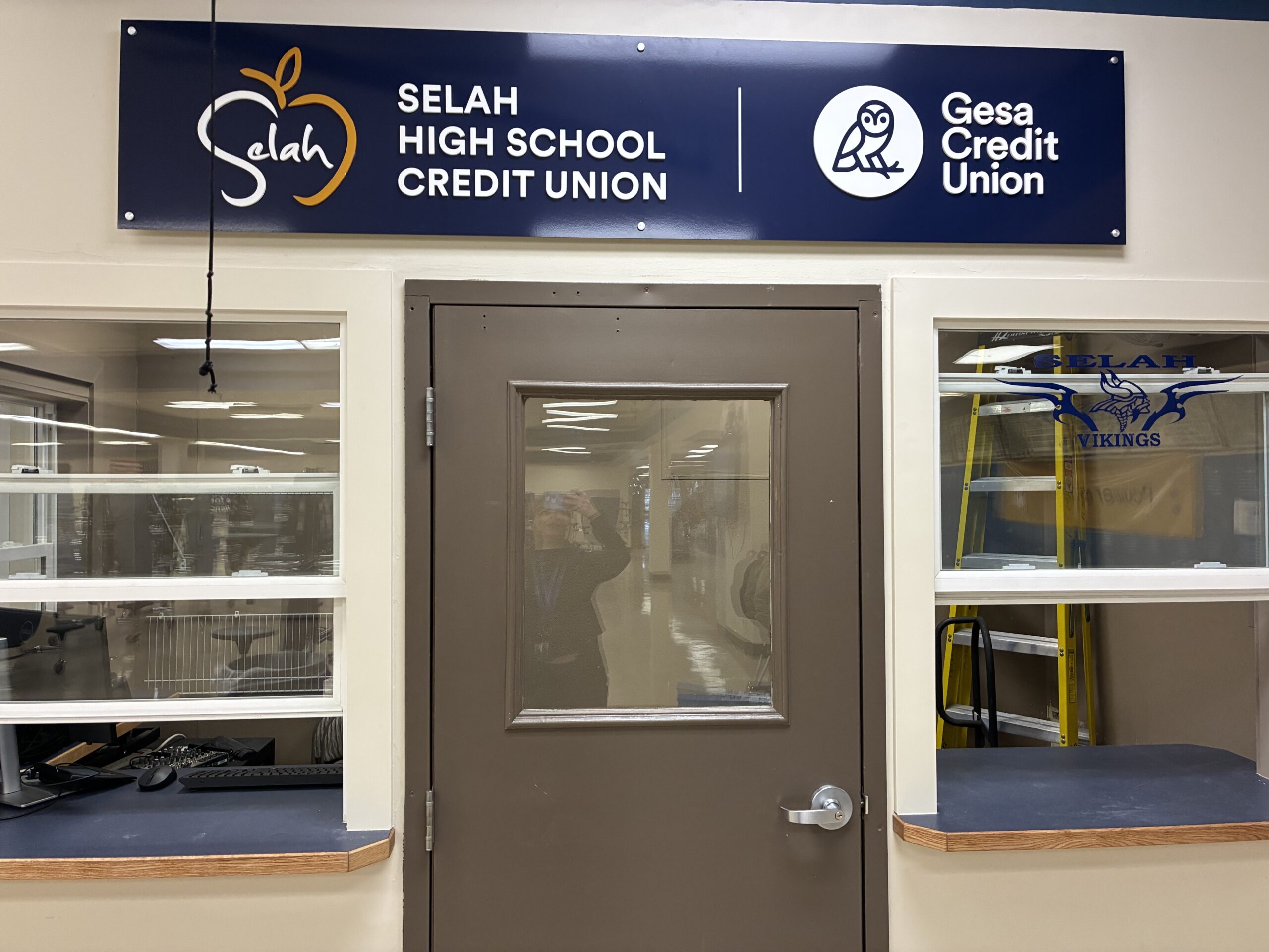 Photo of a door facing into a school hallway with a sign above that says Selah High School Credit Union