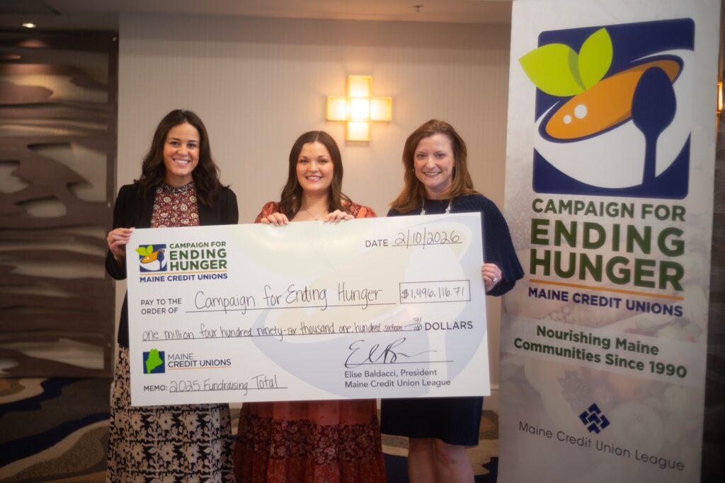 three people holding a big check made out to Campaign for Ending Hunger for $1,496,116.71