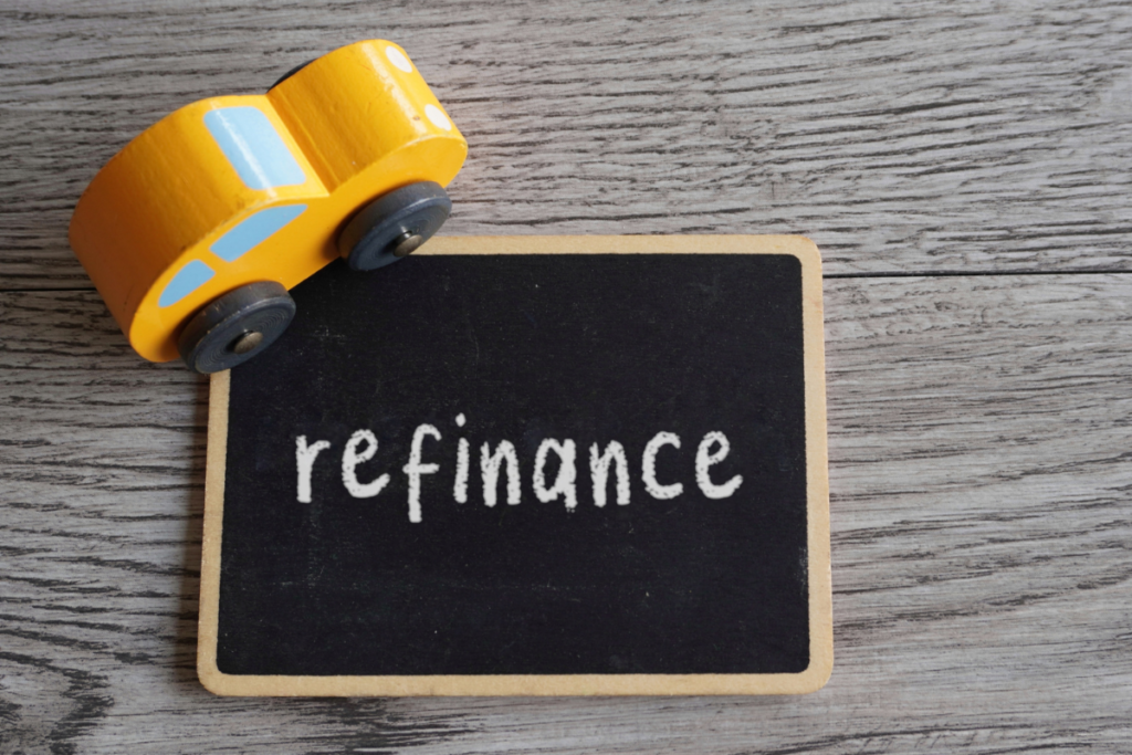 Toy car and text REFINANCE with copy space. Car loan refinancing concept
