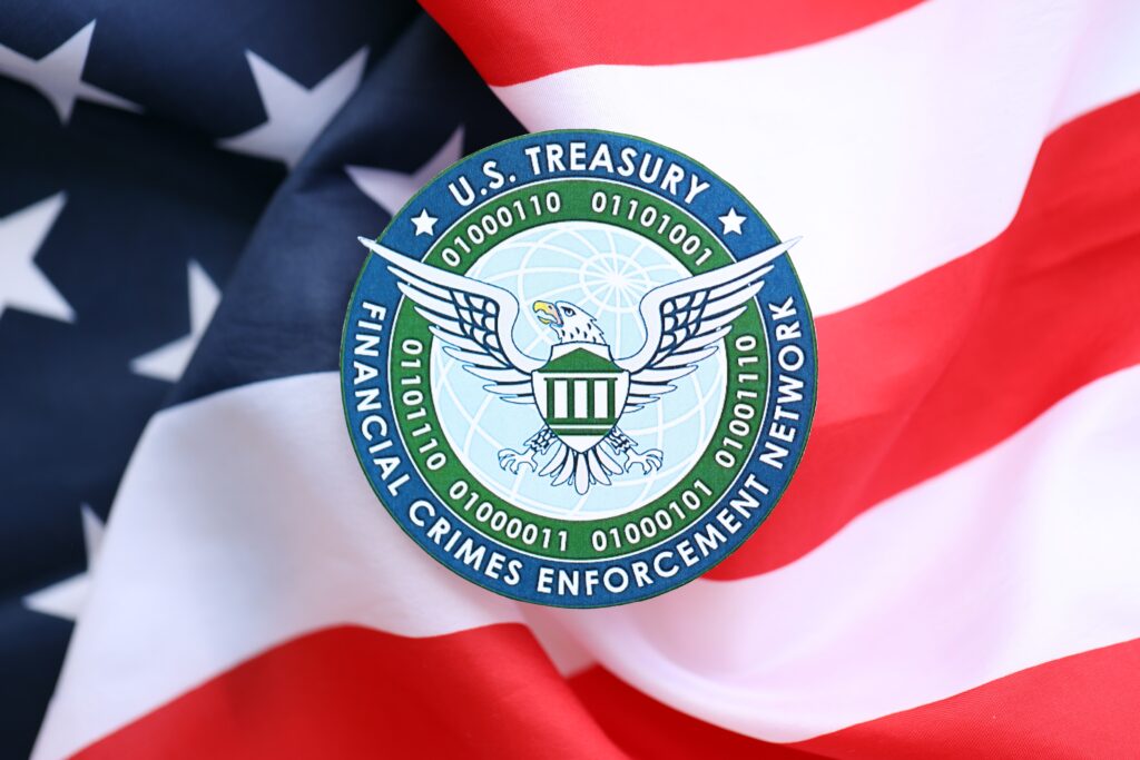U.S. Treasury Financial Crimes Enforcement Network coat of arms sticker on folded US flag close up