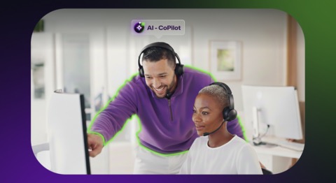 man and woman looking at computer screen with man standing and pointing to something on the screen