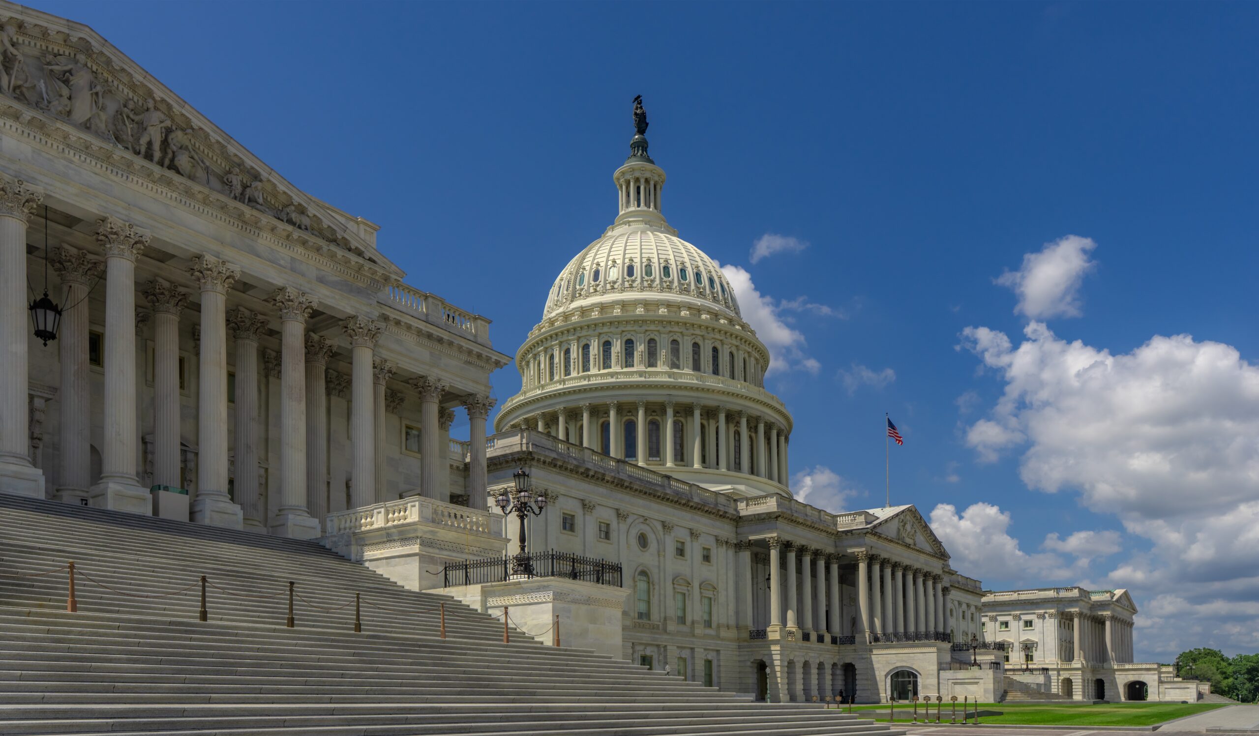 Washington DC federal landmark. United States Capitol architecture. Congress building in the capital. American government house. Flag waving at Capitol Hill. Famous Washington DC monument.