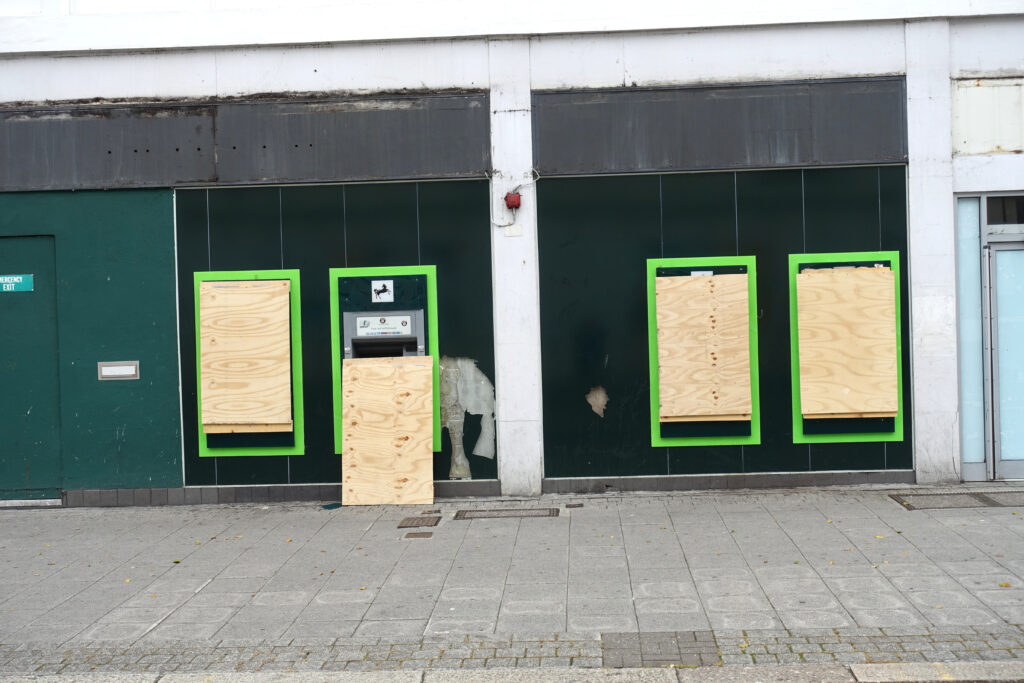 Bank closure. city centre. Four outside cash dispensing machines being boarded up. All signage has been removed