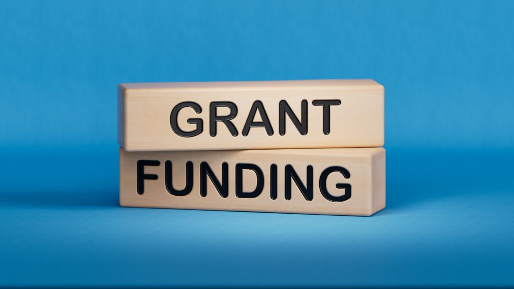 Grant funding symbol. Wooden blocks with words Grant funding.Business and Grant funding concept. Copy space.3D rendering on blue background.