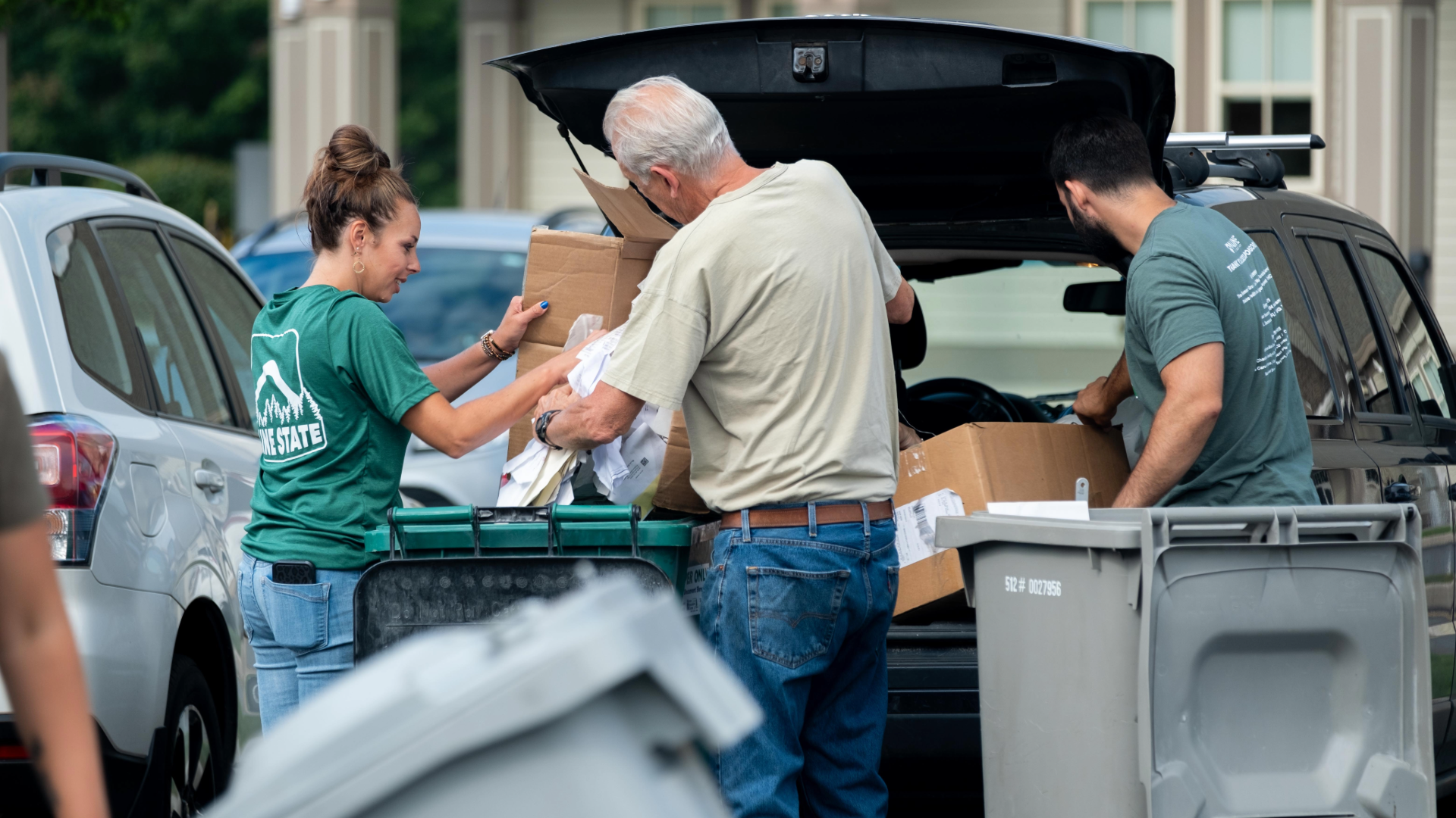 people dropping paper work in a bin for Shred-It Day