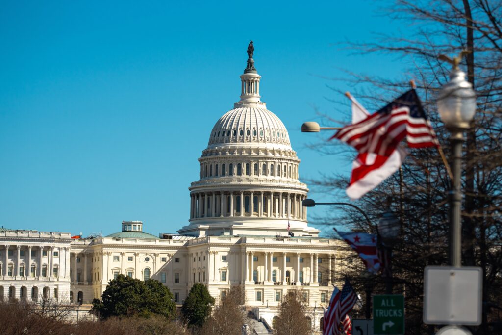 The United States Capitol as a symbol of democracy in Washington, DC. The Capitol building on Capitol Hill. US government. American flag adorns the dome of the historic Capitol. The Senate.