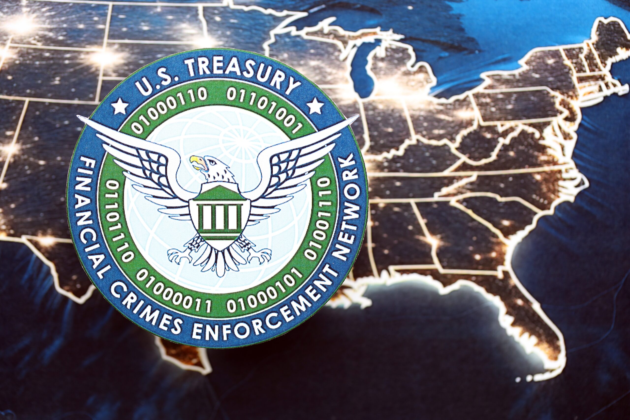 KYIV, UKRAINE - JUNE 26, 2024 U.S. Treasury Financial Crimes Enforcement Network coat of arms on paper map of United States of America